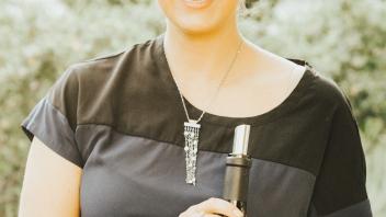 Volunteer holding wine.