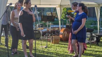 Emcees on grass.